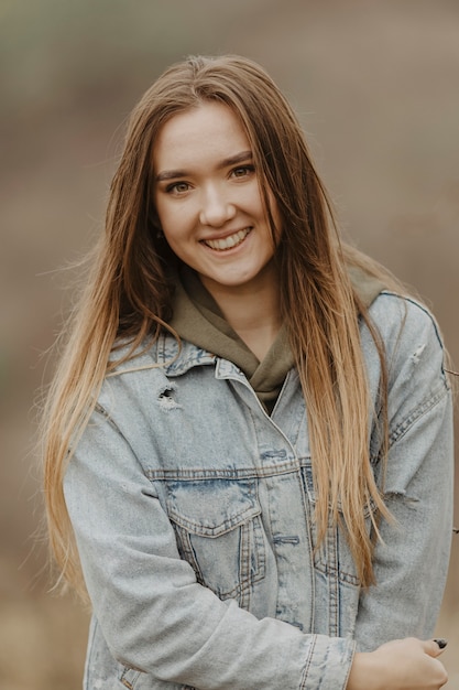 Foto gratuita vista frontal mujer sonriente en la naturaleza