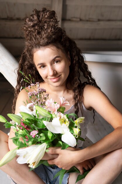 Vista frontal mujer sosteniendo flores