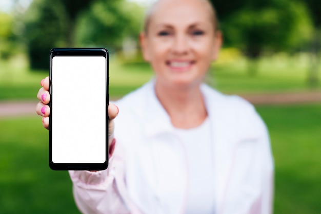 Foto gratuita vista frontal mujer sosteniendo un teléfono inteligente