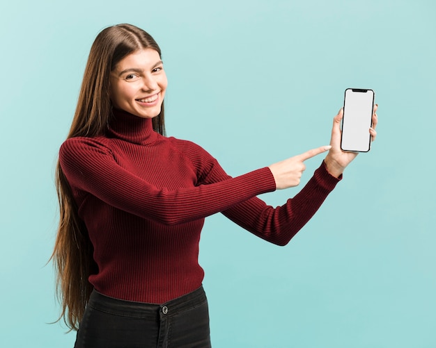 Foto gratuita vista frontal mujer sosteniendo un teléfono inteligente