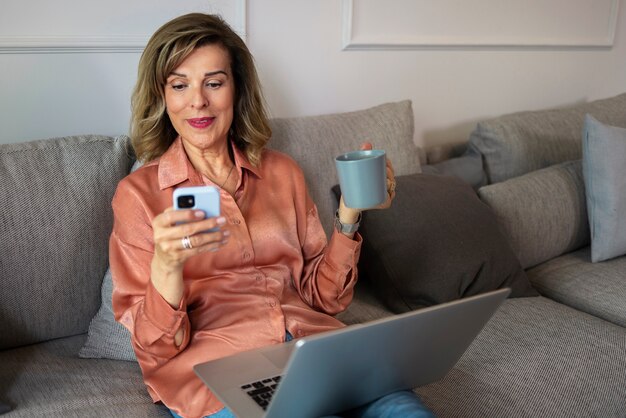 Vista frontal mujer tomando un descanso con teléfono inteligente