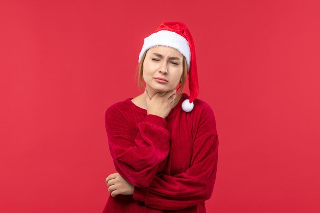 Vista frontal de las mujeres jóvenes con dolor de garganta, vacaciones de Navidad roja