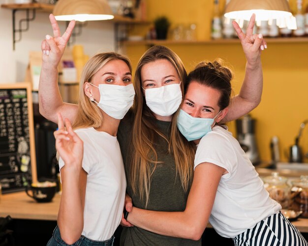 Vista frontal de las mujeres jóvenes con mascarilla