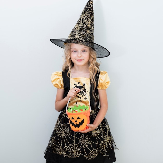 Foto gratuita vista frontal niña en traje de bruja para halloween