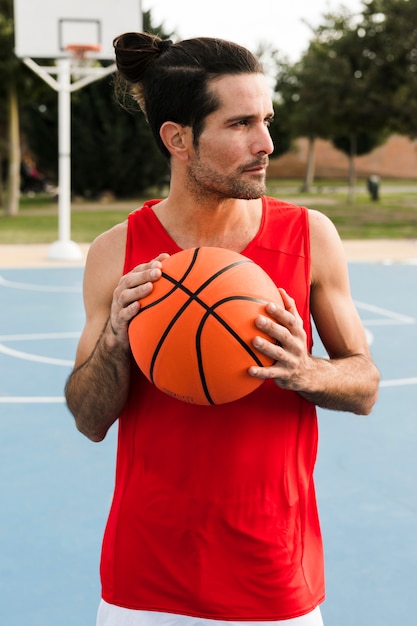 Foto gratuita vista frontal del niño con pelota de baloncesto