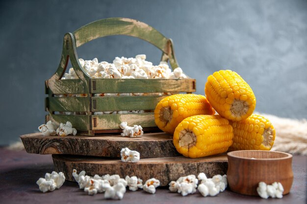 Vista frontal de palomitas de maíz frescas con granos amarillos en el escritorio oscuro, palomitas de maíz, comida de maíz