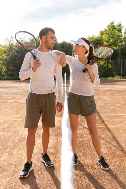 Vista frontal pareja en cancha de tenis