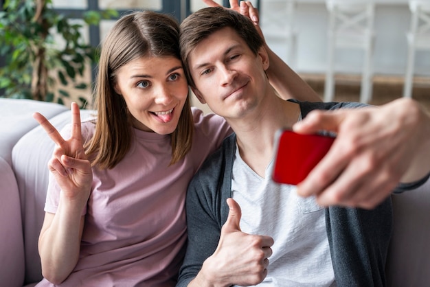 Vista frontal de la pareja tomando una selfie