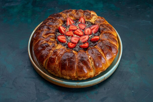 Vista frontal del pastel de fresa con mermelada y fresas frescas sobre superficie azul