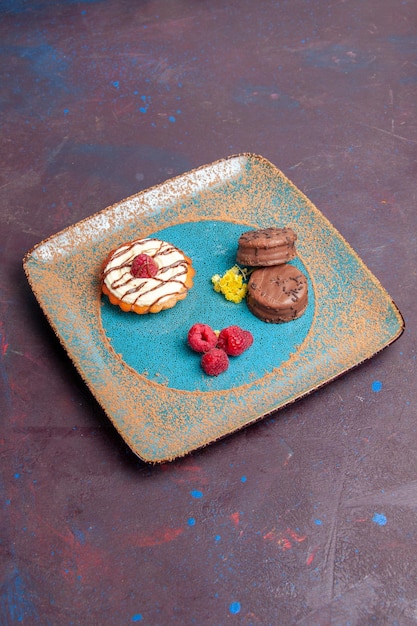 Foto gratuita vista frontal pequeño pastel cremoso con galletas de chocolate sobre fondo oscuro pastel de azúcar de galleta pastel dulce