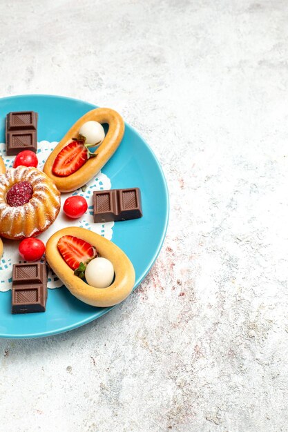 Vista frontal pequeño pastel con galletas dulces de chocolate y fresas sobre un fondo blanco pastel de galletas de frutas pastel de galletas dulces