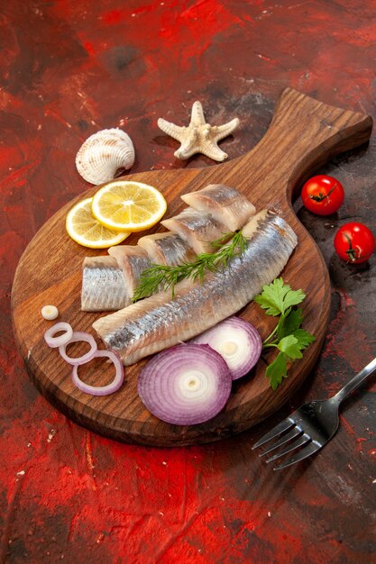 Vista frontal de pescado crudo en rodajas con aros de cebolla en bocadillo de carne de ensalada de color marisco oscuro