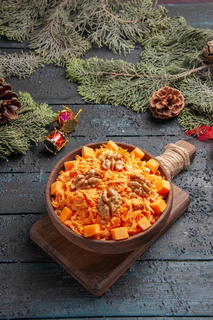 Vista frontal sabrosa ensalada de zanahoria con nueces sobre fondo azul oscuro ensalada de salud alimentaria tuerca de dieta de color