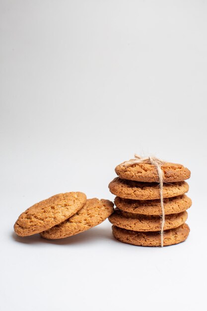 Vista frontal sabrosas galletas dulces en galletas blancas postre té foto pastel azúcar