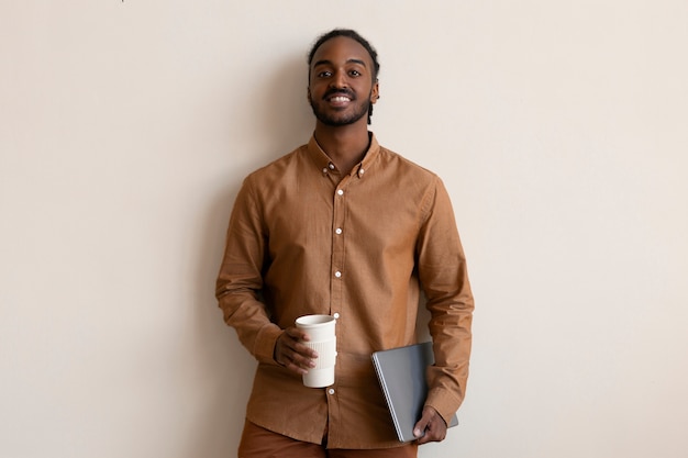 Vista frontal sonriente hombre sosteniendo taza de café