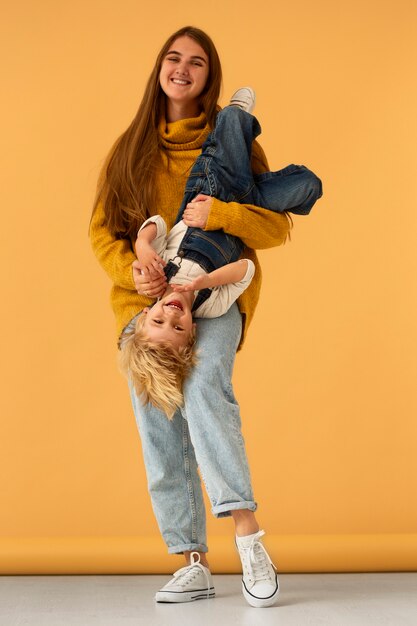 Vista frontal sonriente madre y niño en estudio