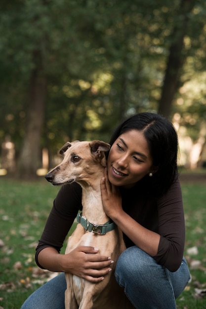 Foto gratuita vista frontal sonriente mujer sosteniendo perro