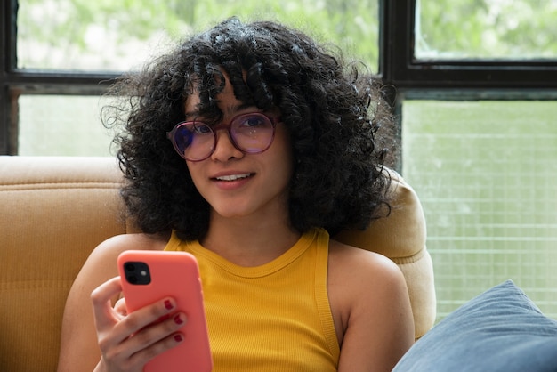 Vista frontal sonriente mujer sosteniendo teléfono