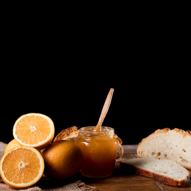 Foto gratuita vista frontal del tarro de mermelada de naranja con espacio de copia