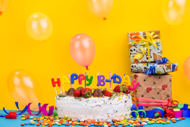 Foto gratuita vista frontal tarta cumpleaños con regalos