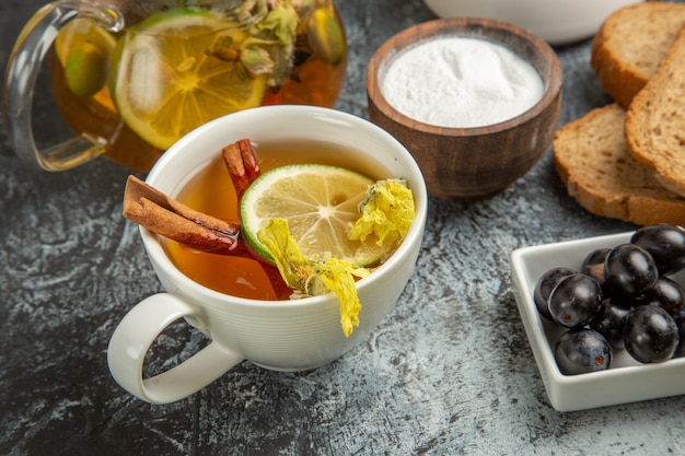 Vista frontal de la taza de té con aceitunas y pan en la mañana de desayuno de alimentos de superficie ligera