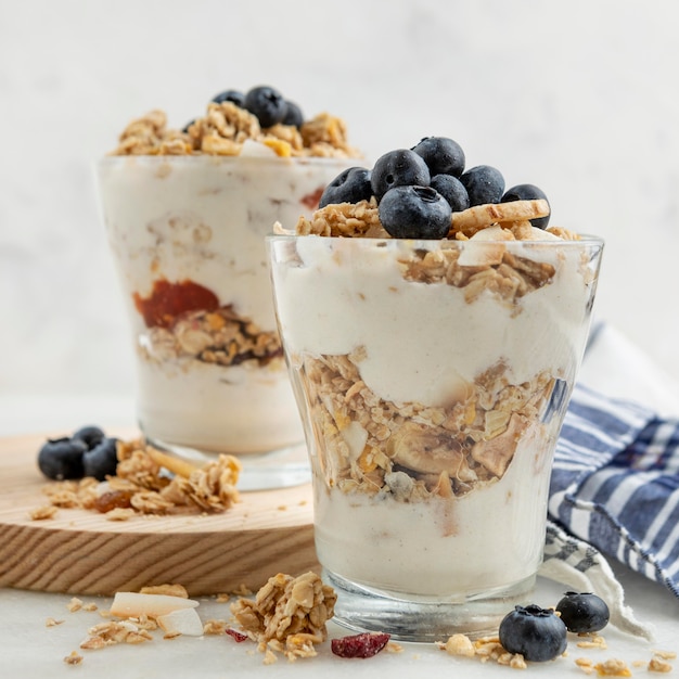 Vista frontal de vasos con yogur y cereales para el desayuno