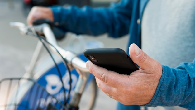 Vista frontal del viejo hombre con bicicleta