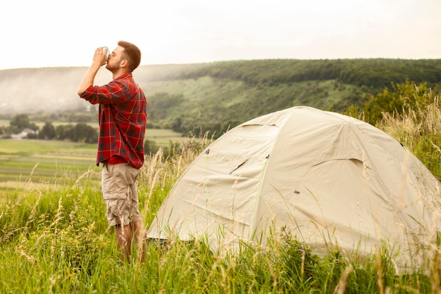 Vista lateral de camping masculino