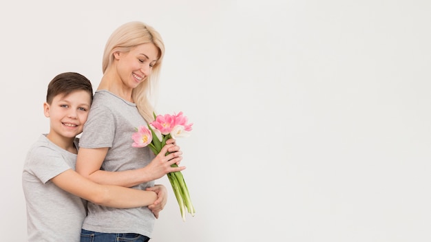 Foto gratuita vista lateral hijo abrazando a su madre