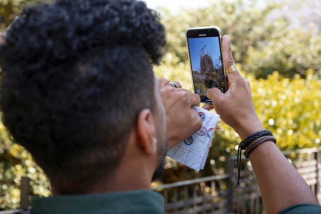 Foto gratuita vista lateral hombre tomando fotos con teléfono inteligente