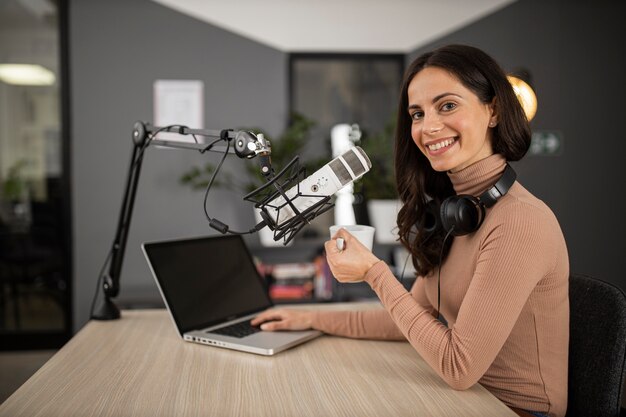 Vista lateral de la mujer feliz haciendo radio