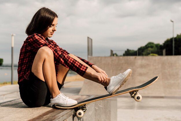 Vista lateral de la mujer en el skate park