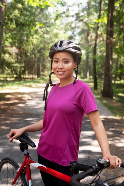 Foto gratuita vista lateral mujer sonriente con bicicleta