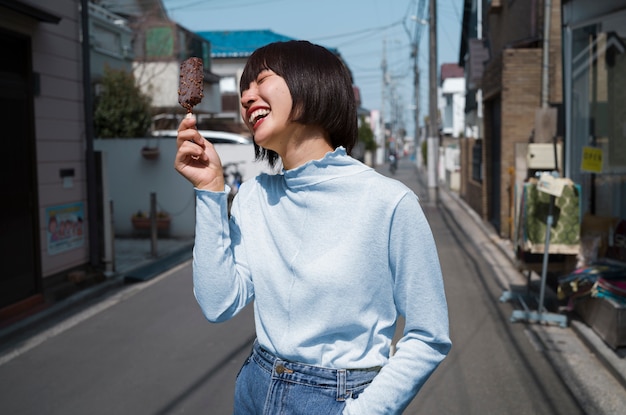 Vista lateral mujer sonriente con delicioso helado