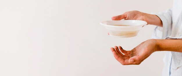 Vista lateral de la persona que sostiene un tazón de comida con espacio de copia