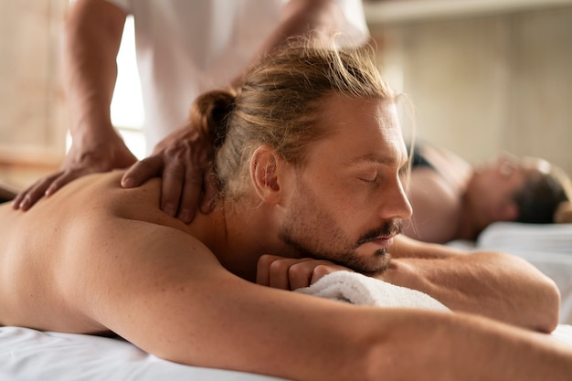 Foto gratuita vista lateral de personas recibiendo un masaje