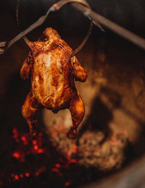 Vista lateral de pollo al horno en un horno de barro