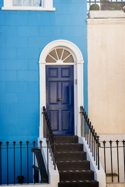 Vista lateral de la puerta delantera con pared azul y beige.