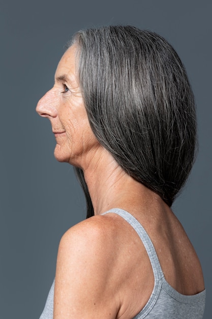 Foto gratuita vista lateral sonriente mujer senior con cabello gris