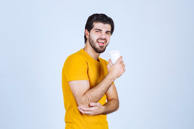 Vista de perfil de un hombre tomando café.