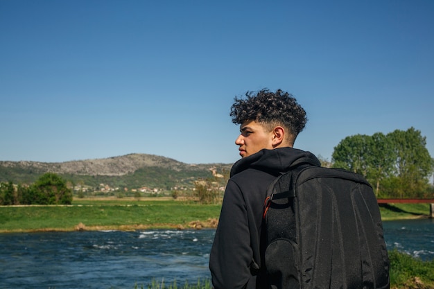 Foto gratuita vista posterior de la mochila que lleva turista mirando vista panorámica