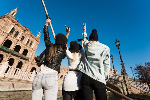 Vista posterior de mujeres tomando selfie a bordo