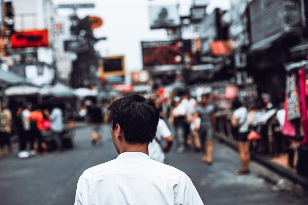 Vista posterior del retrato joven asiático caminando en khaosan road bangkok