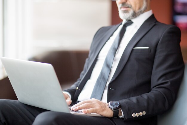 Vista recortada del hombre de negocios usando tableta