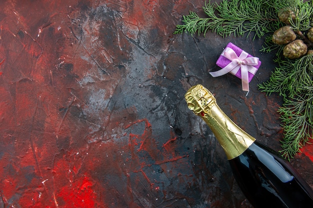 Vista superior botella de champán con regalos en color oscuro beber alcohol foto fiesta de año nuevo espacio libre