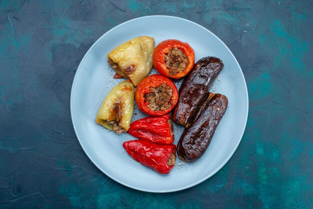 Vista superior de la carne dentro de verduras dolma dentro de la placa en el escritorio azul oscuro comida carne cena salud engorde