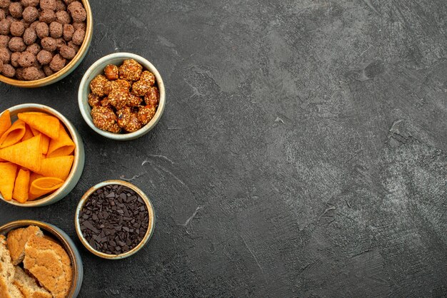 Vista superior de cips de naranja con nueces dulces y hojuelas de chocolate en la superficie gris comida snack desayuno tuerca