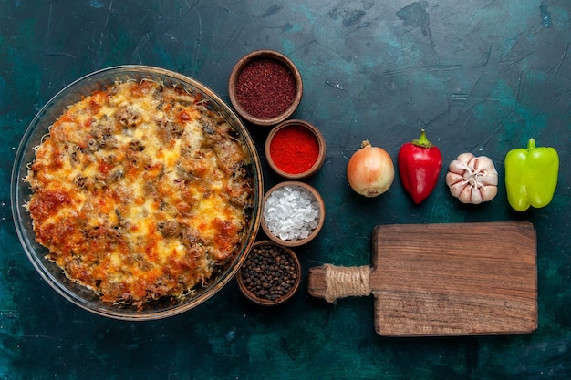 Foto gratuita vista superior comida de carne con queso sabroso horneado con verduras frescas y condimentos en el escritorio azul oscuro comida carne plato de comida cena de verduras