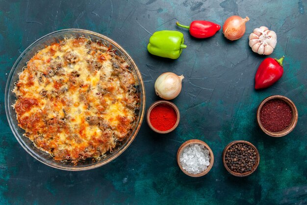 Vista superior de la comida de carne con queso con verduras frescas y condimentos sobre fondo azul oscuro, comida, comida, carne, plato, verduras, cena