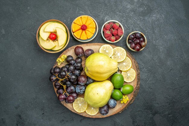 Vista superior de la composición de diferentes frutas frescas y maduras sobre fondo gris oscuro frutas maduras suaves salud fresca